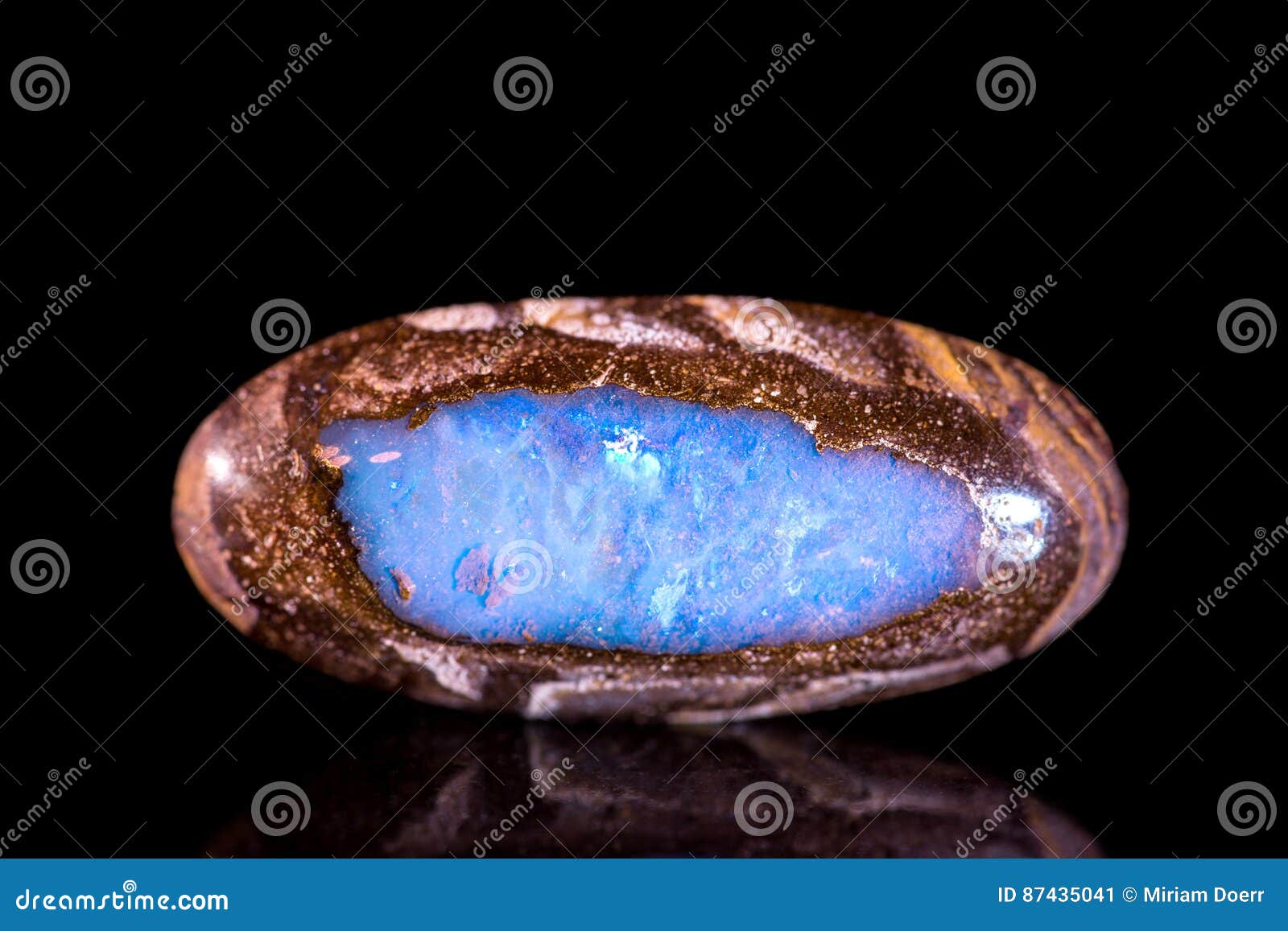 opal between a bedrock, black background, mineral gemstone, heal