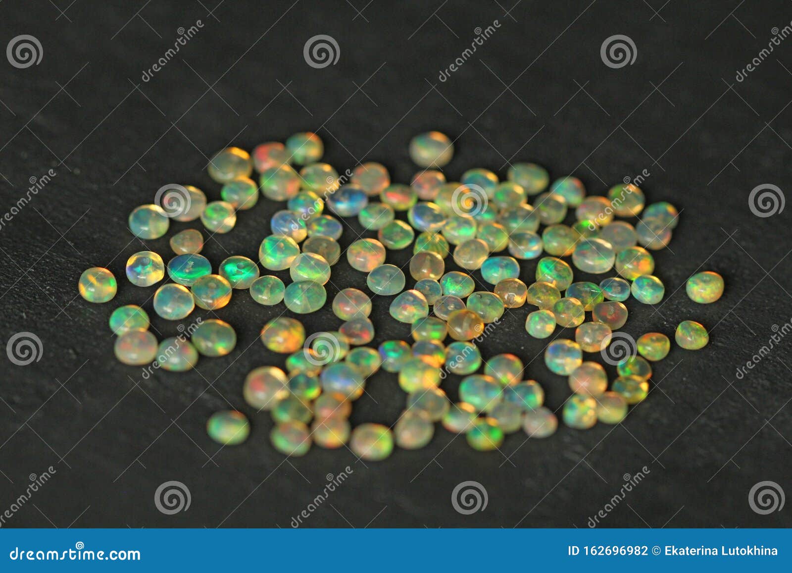 opals gemstone from ethiopia lies on black background. white fire opals with rainbowlike fire. natural fire ethiopian opal, small