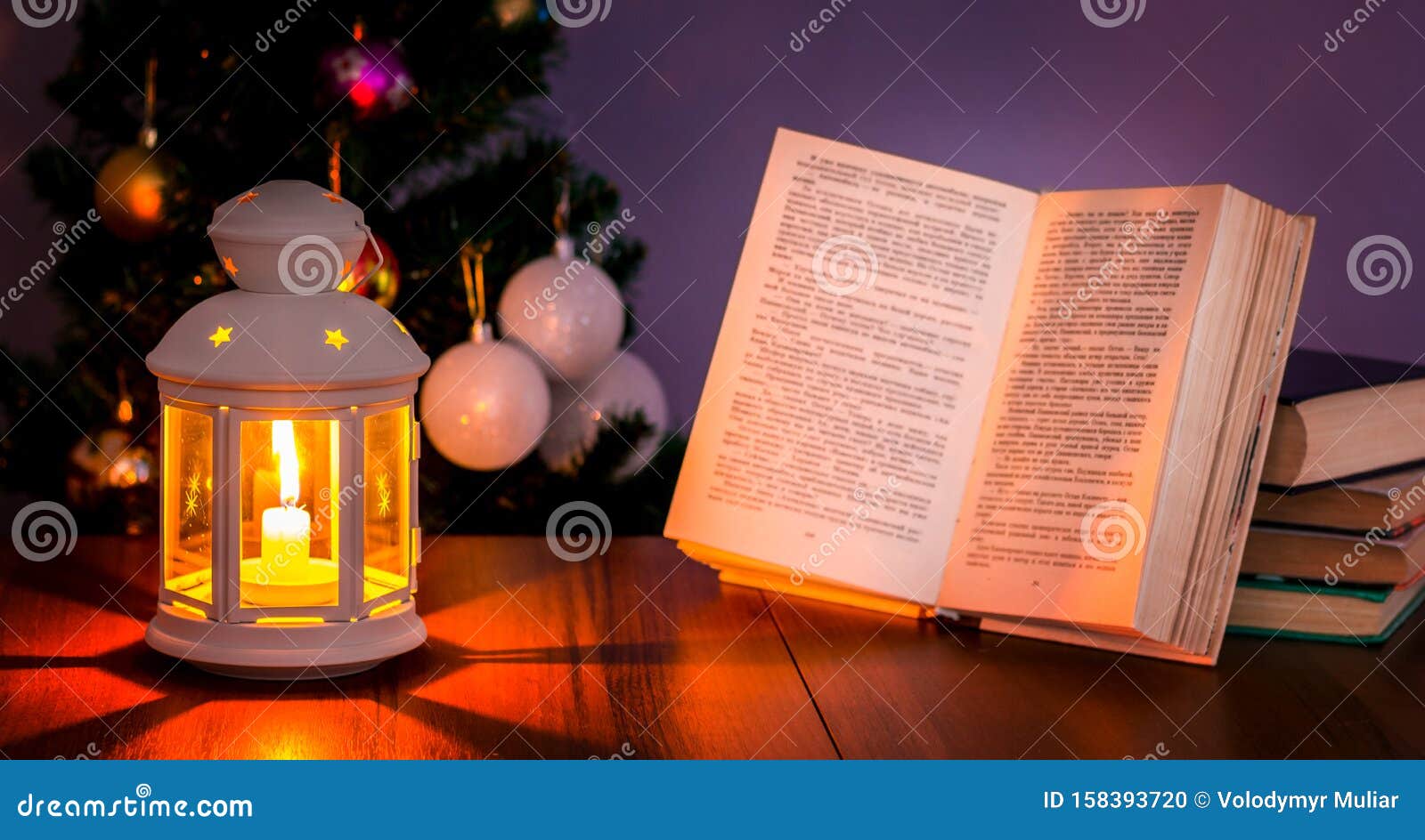 Open Book Illuminated by Lantern an Under the Christmas Tree_ Stock