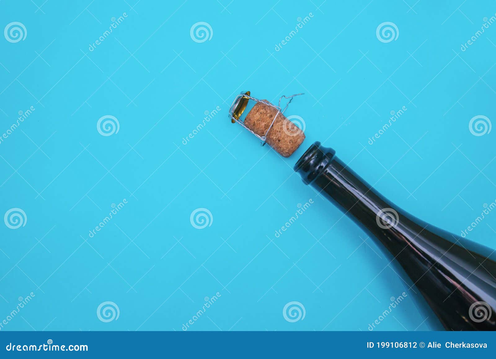An Open Bottle of Champagne on a Blue Background. the Champagne Cork
