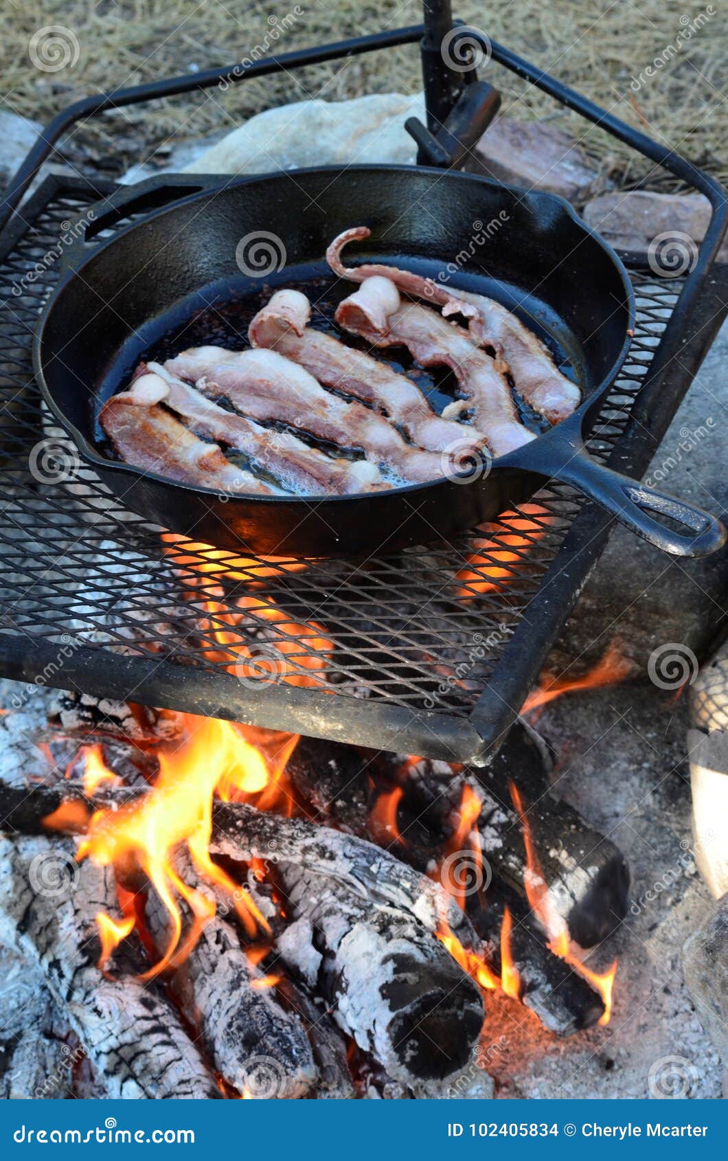 Bacon in a Cast Iron Frying Pan Cooking on a Campfire ! Stock Photo - Image  of black, cooking: 102405834