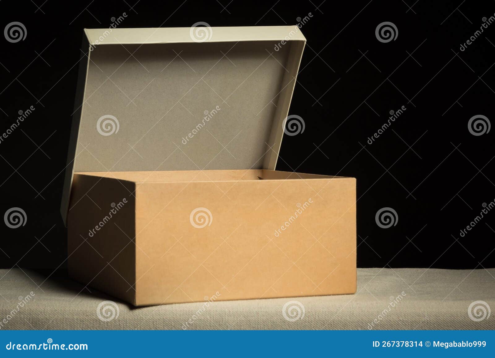Open Cardboard Box on Black Background, Copy Space Stock Photo Image