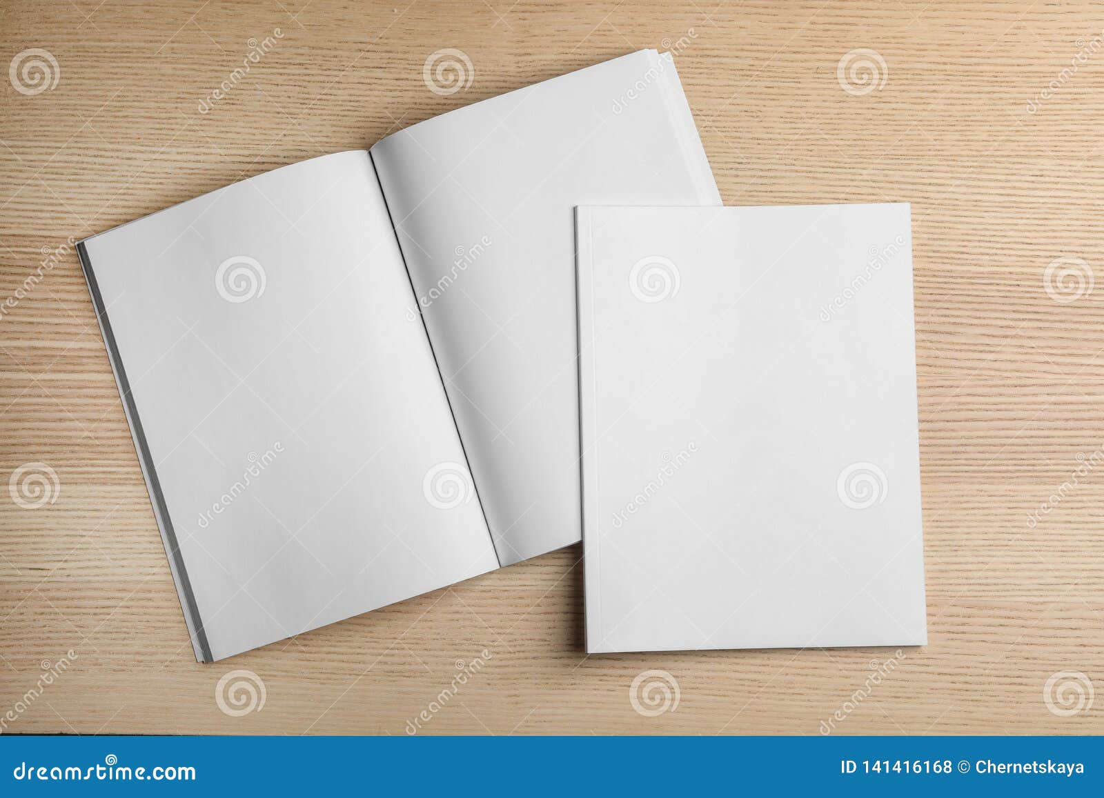 open and closed blank brochures on wooden background, top view.
