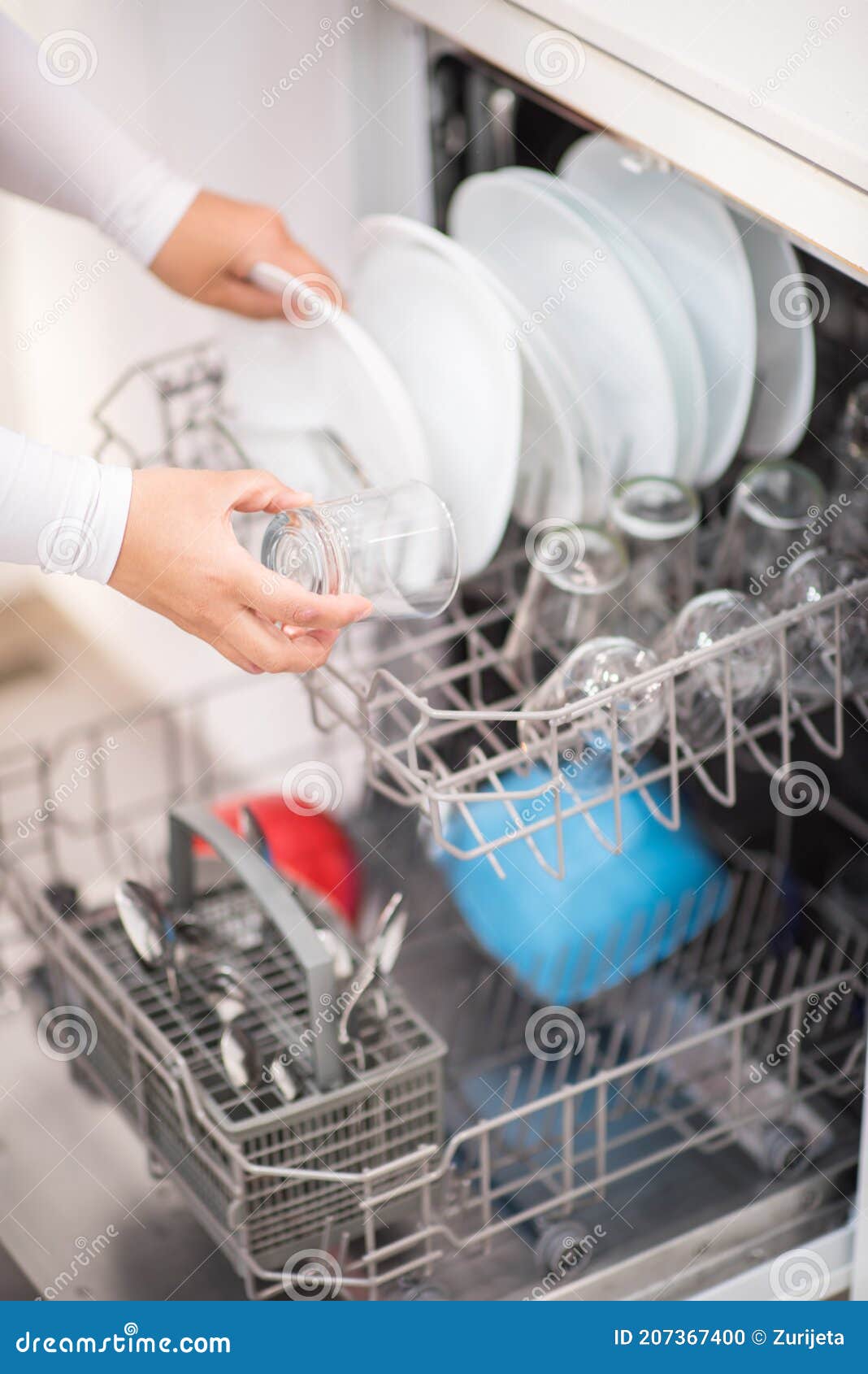 open dishwasher with clean glass and dishes