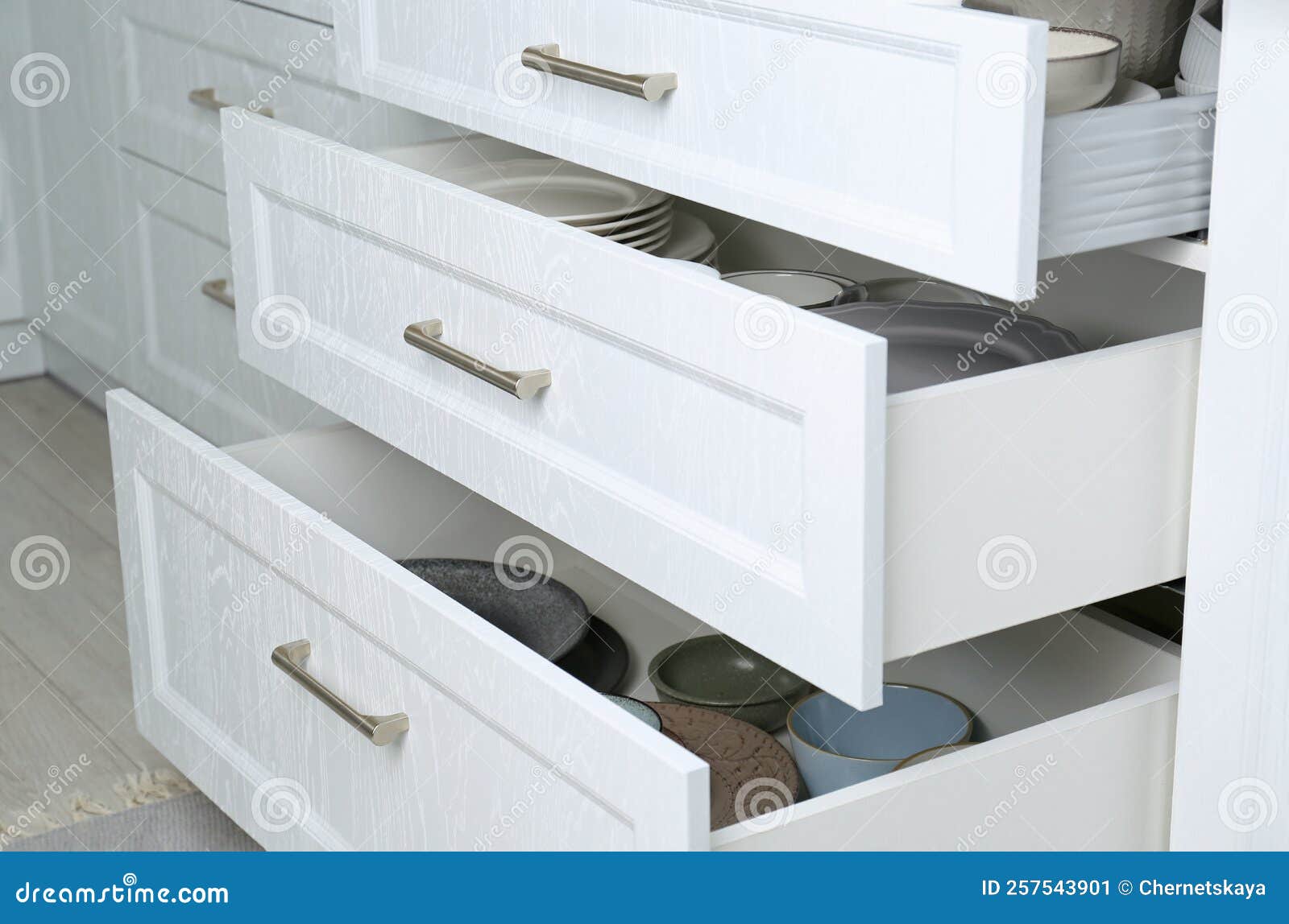 Open Drawers with Different Plates and Bowls in Kitchen Stock Image