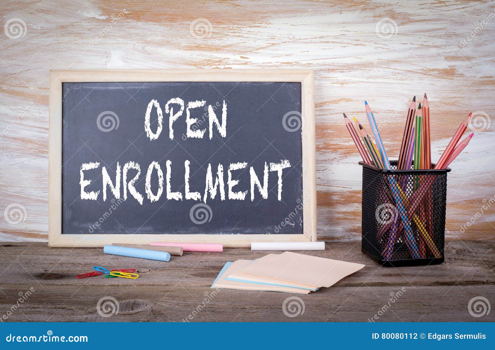 open enrollment text on a blackboard. old wooden table with text