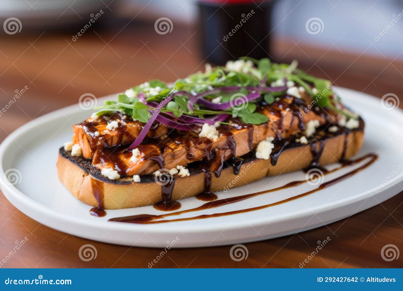 An Openfaced Barbecue Salmon Sandwich on a Ceramic Plate Stock Photo