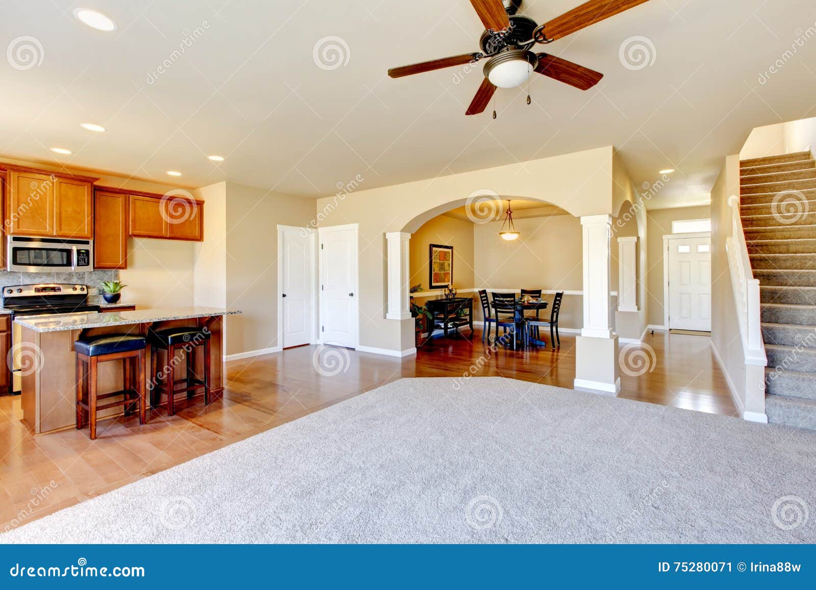 Open Floor Plan View Of Kitchen Dining Room And Entryway Stock