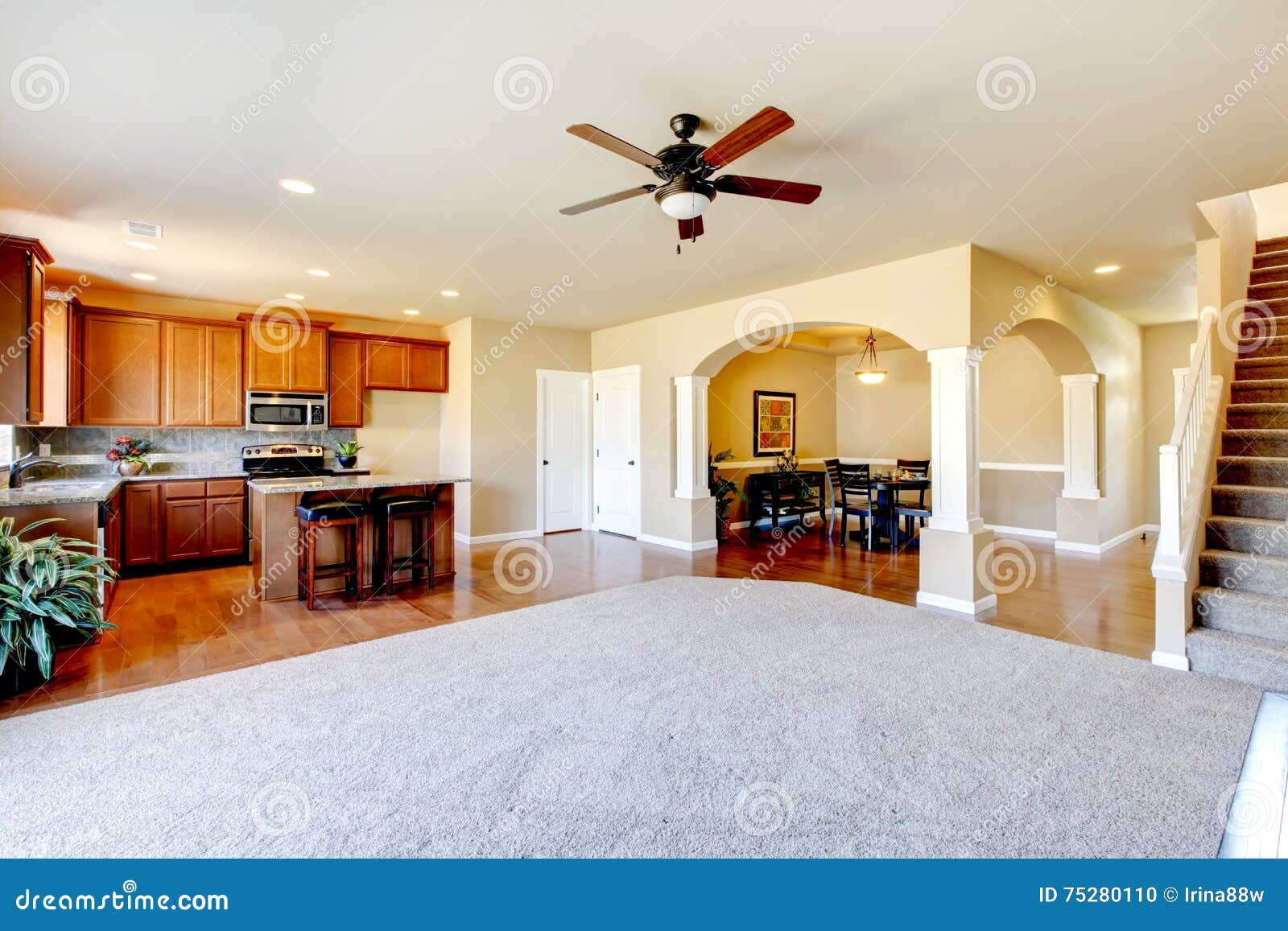 Open Floor Plan View Of Kitchen Dining Room And Entryway Stock