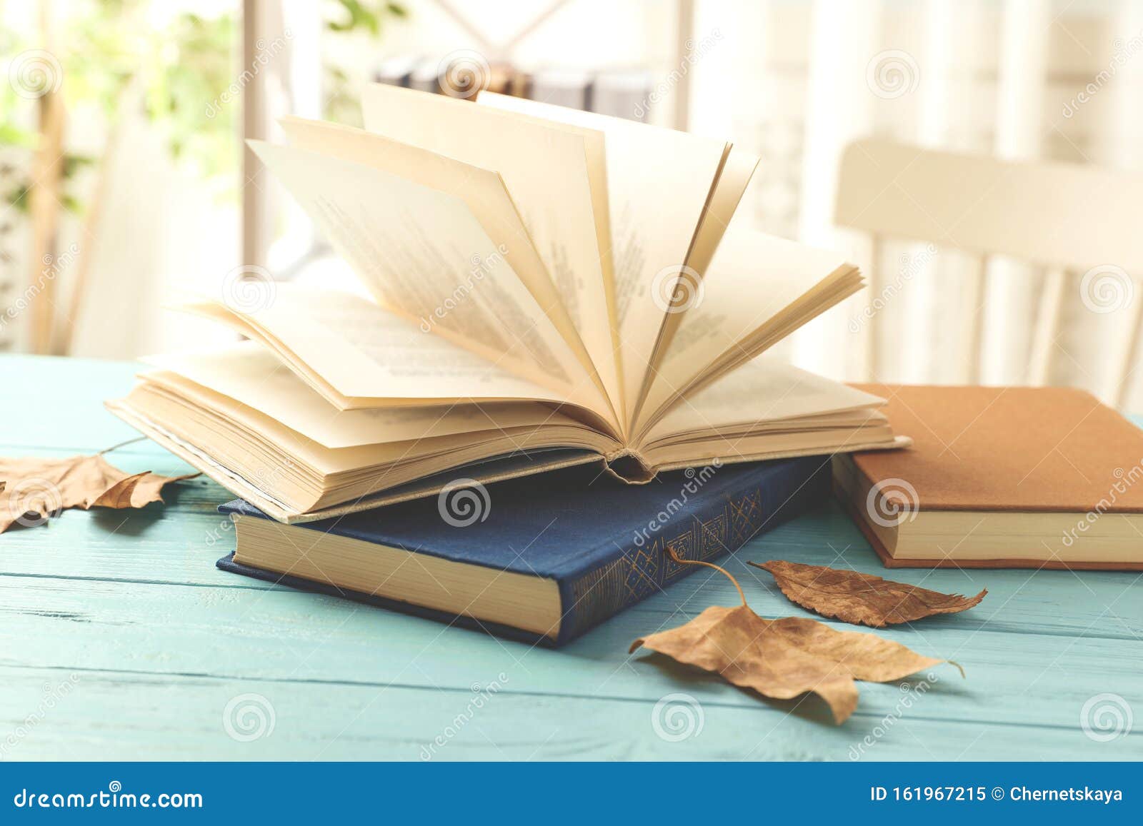 Open Hardcover Book on Light Blue Table Stock Image Image of edition