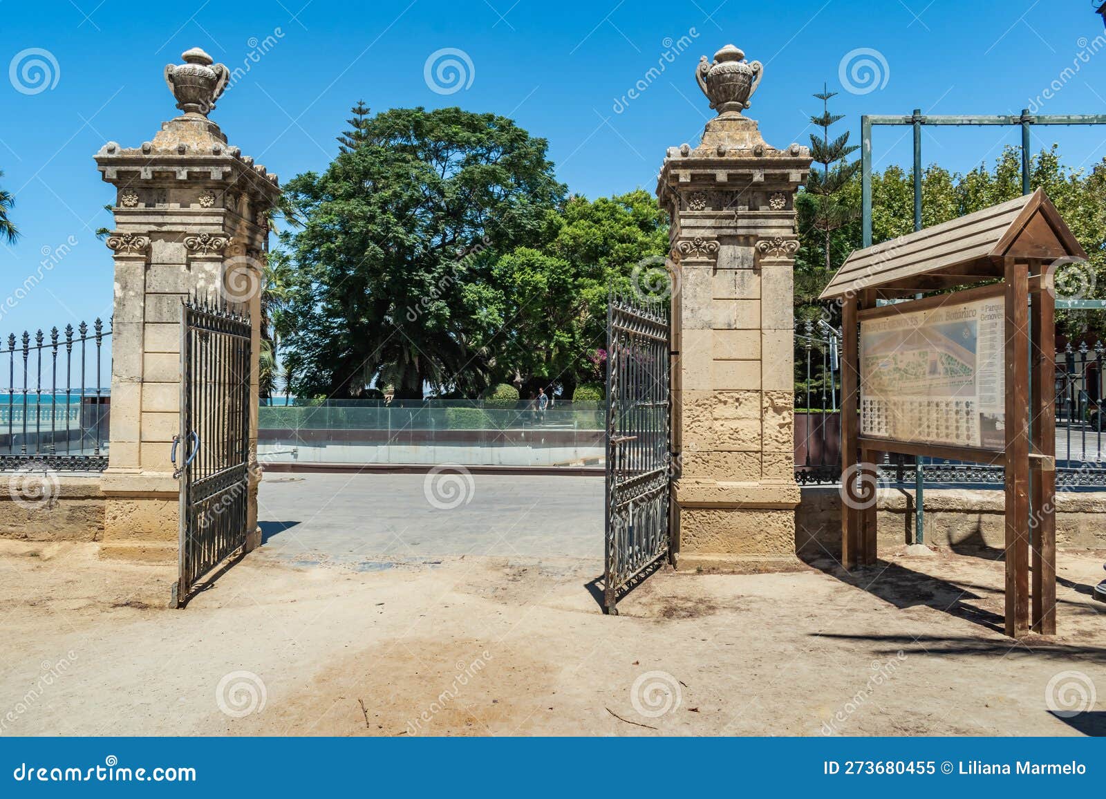 open iron gate with two stone side columns, entrance to genovÃ©s park, cÃ¡diz spain