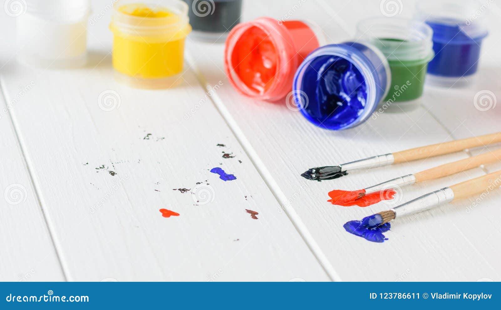Brushes with Bright Colors on a White Wooden Table. Creative Kit. Stock ...