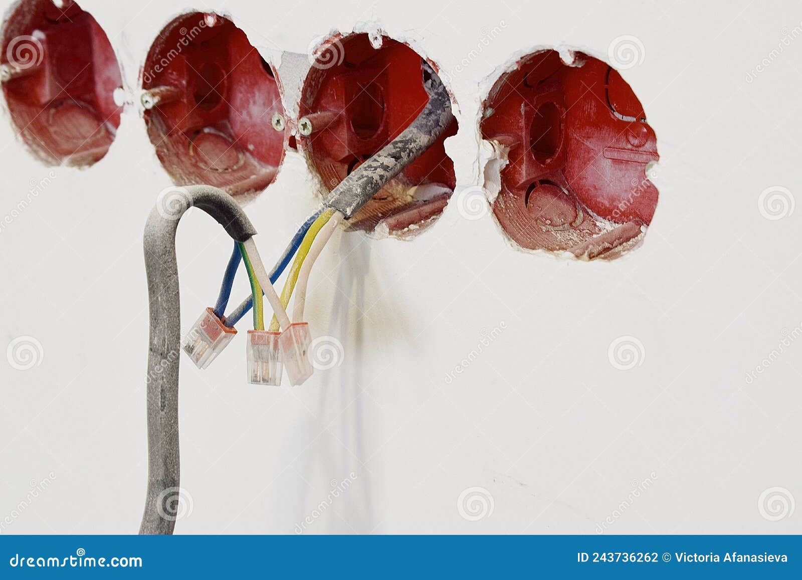 An Open Light Switch with Electrical Wires Hanging from the Wall Stock