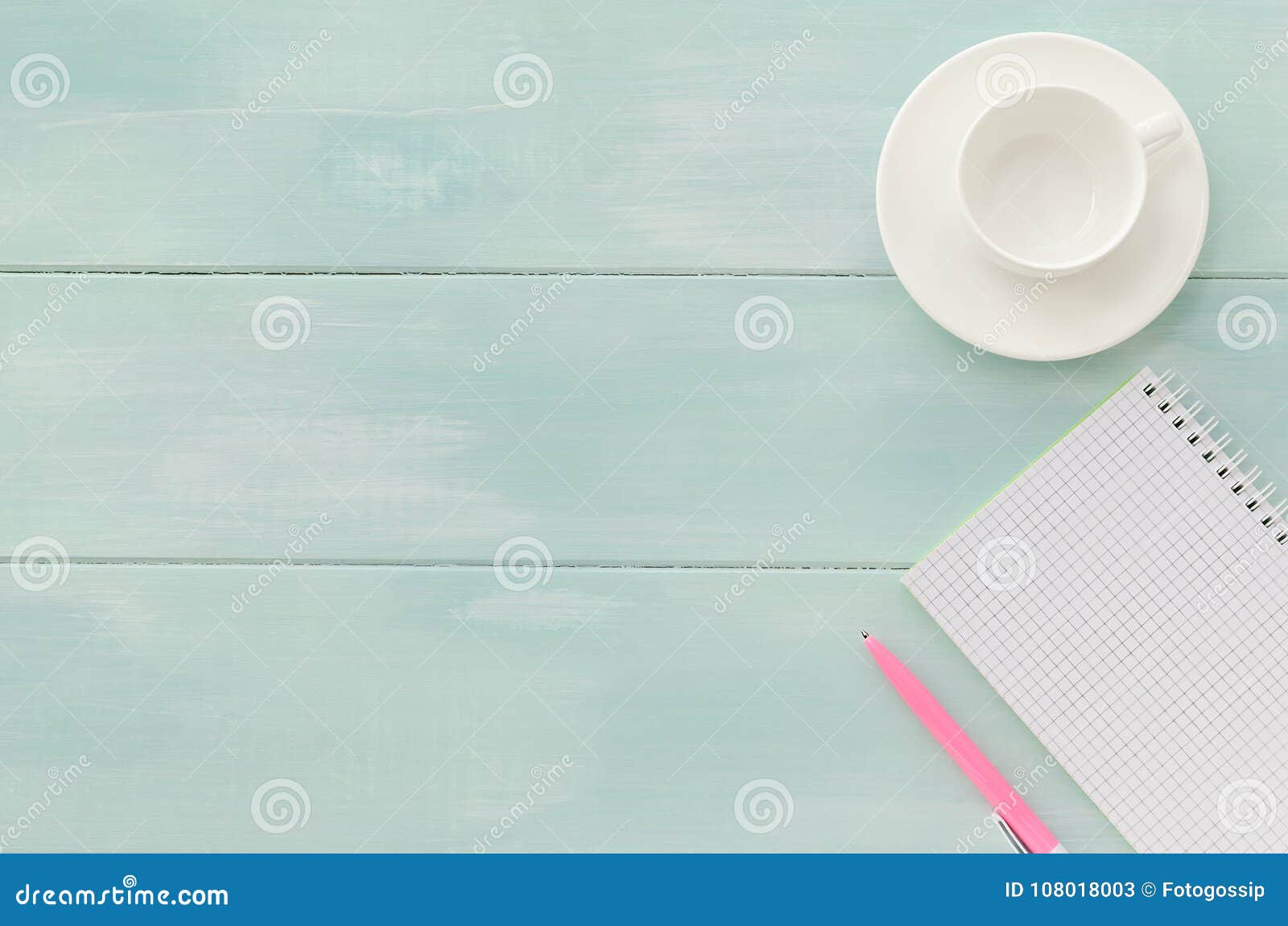 open notebook with pink pen and coffeecup