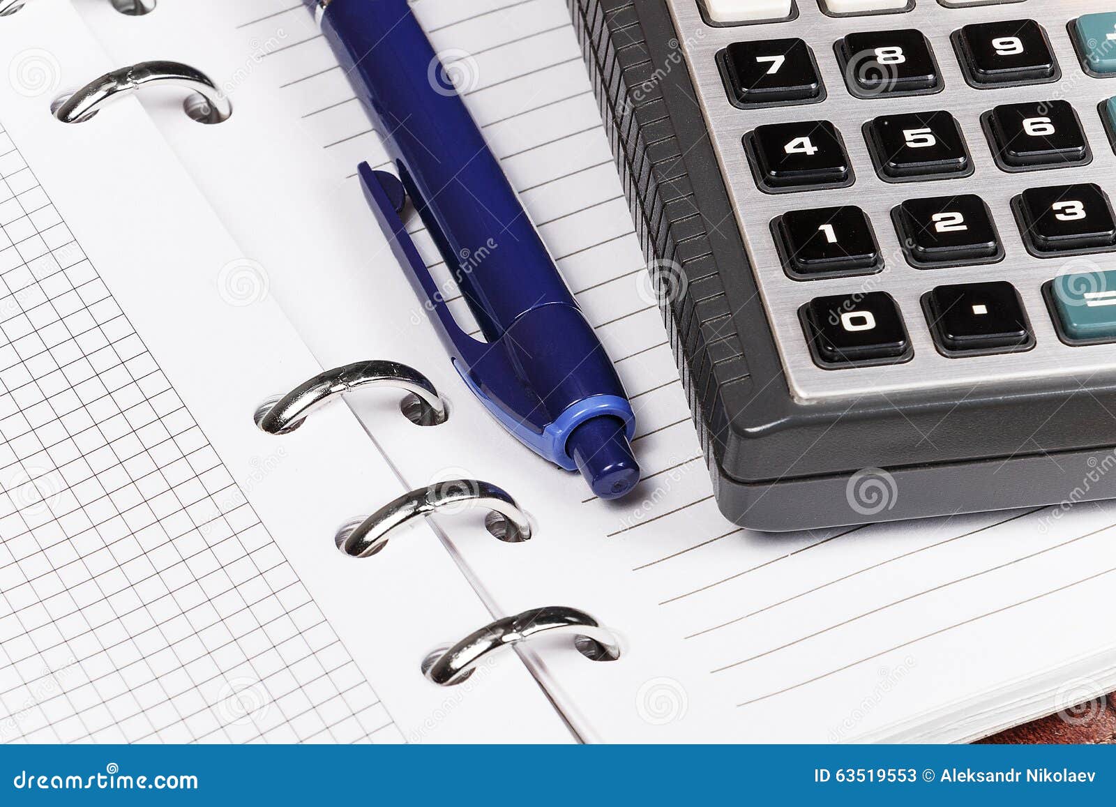 Open Notebook on Which Lies a Blue Pen and Calculator. Stock Image