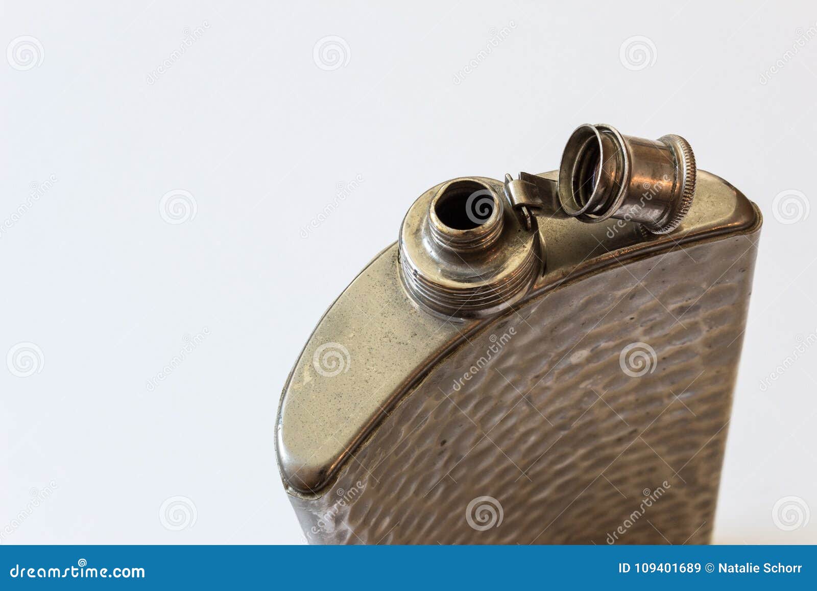 open old peened metal flask  on white, drinking alcoholism addiction concept