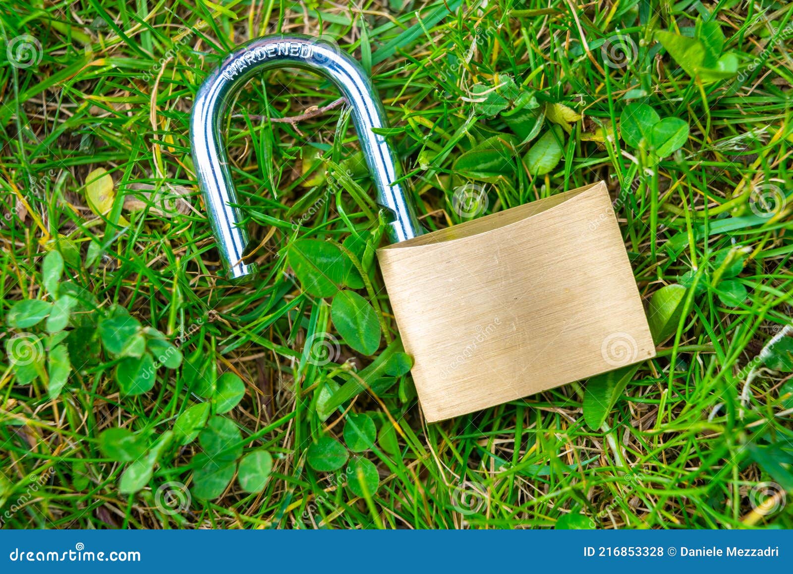 open padlock, placed on the ground