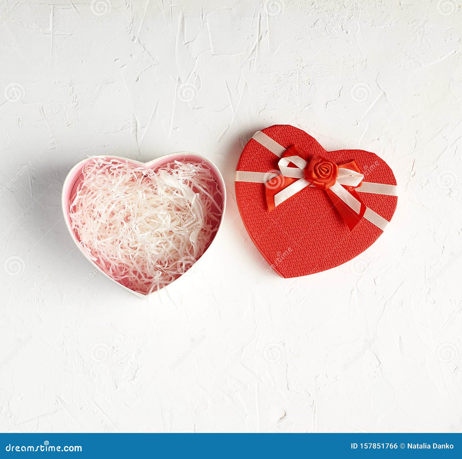 Open Red Heartshaped Gift Box With A Bow On A White