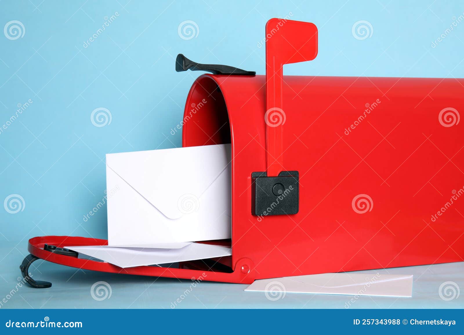 Open Red Letter Box with Envelopes on Turquoise Background, Closeup