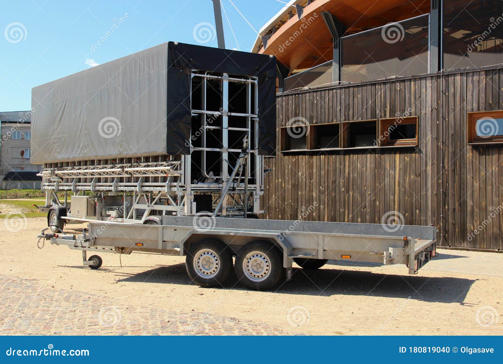 Open and Roofed Car Trailers for Commercial Usage. Transportation Utility for Rent Stock Photo