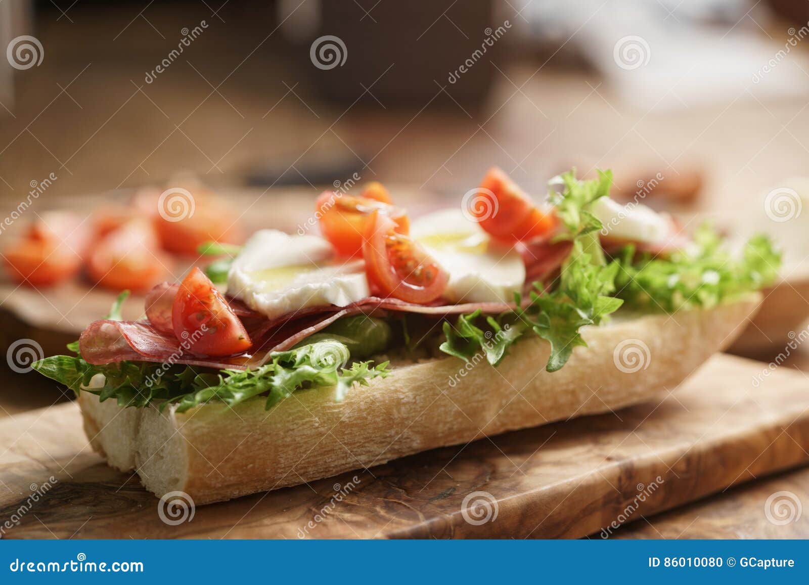 Open Sandwich with Prosciutto, Mozzarella and Tomatoes on Kitchen Table