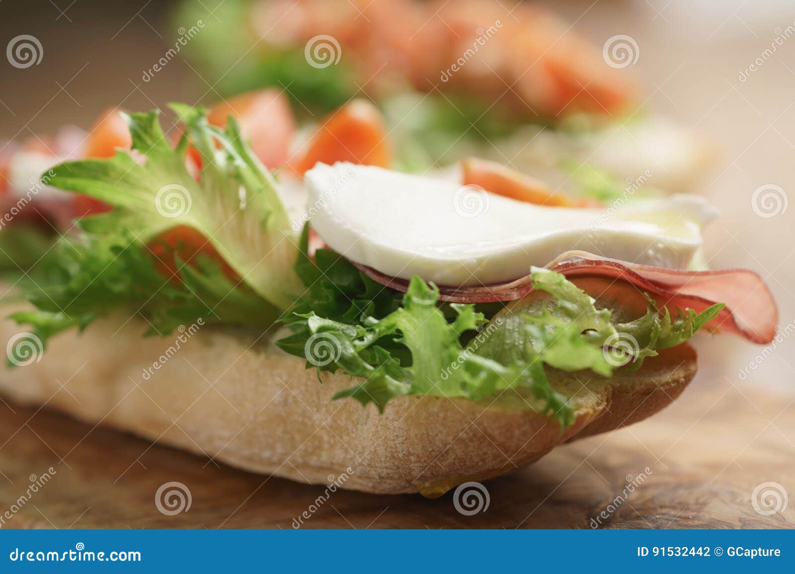 Open Sandwich with Prosciutto, Mozzarella and Tomatoes on Kitchen Table