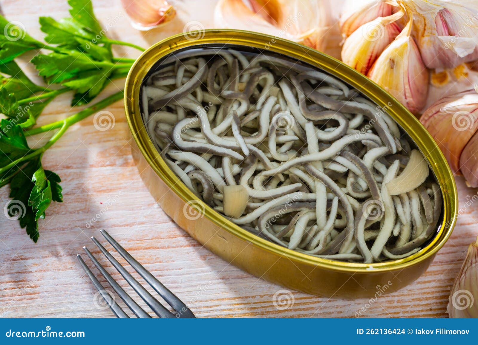 Open Tin Can of Pickled Eels and Garlic with Greens at Table Stock Photo Image of fish