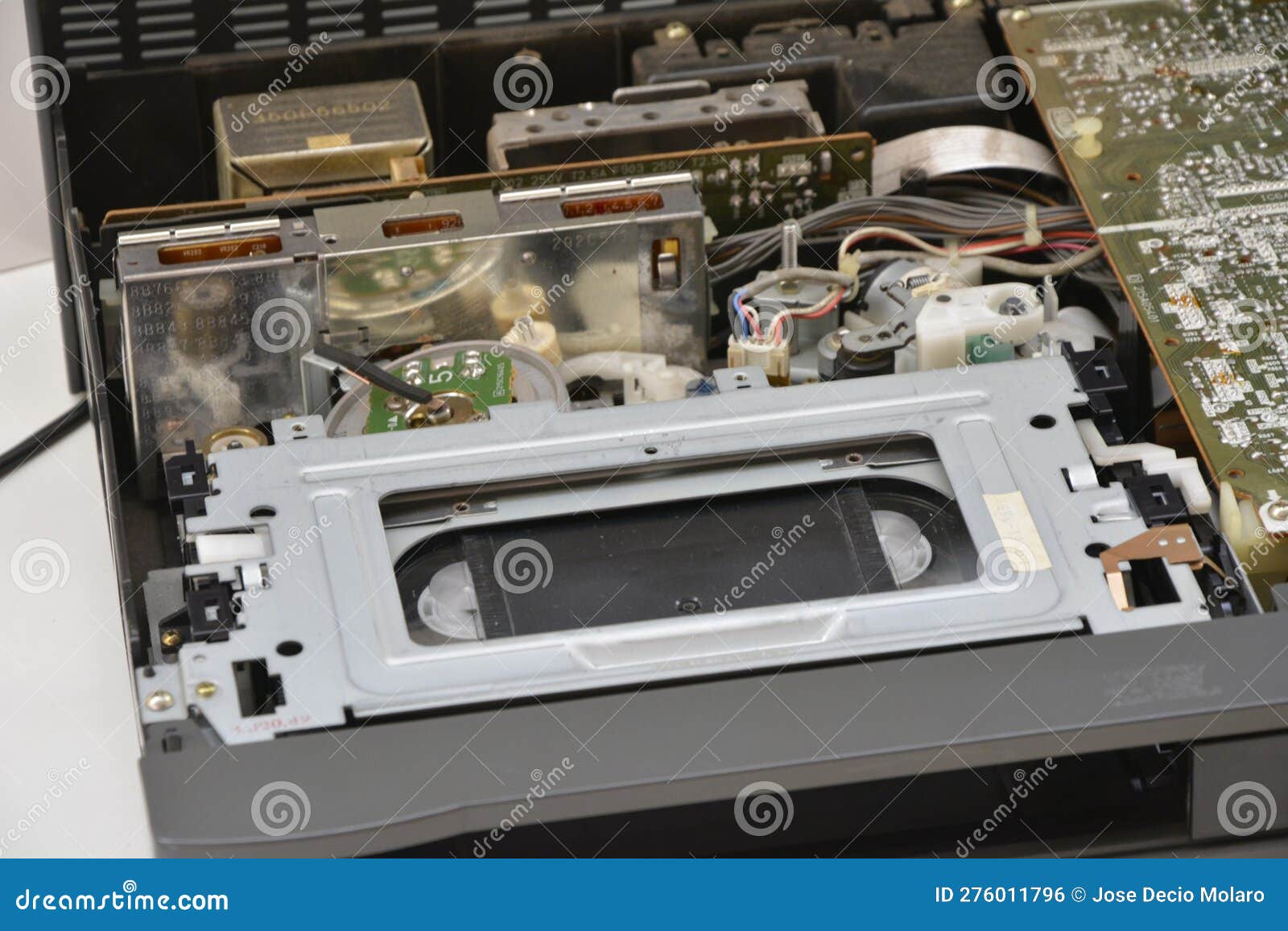 Open Video Cassette Player for Repairs with VHS Tape Stuck in the