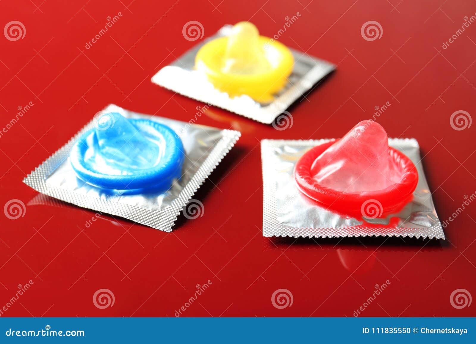 Open And Wrapped Condoms On Color Background. 
