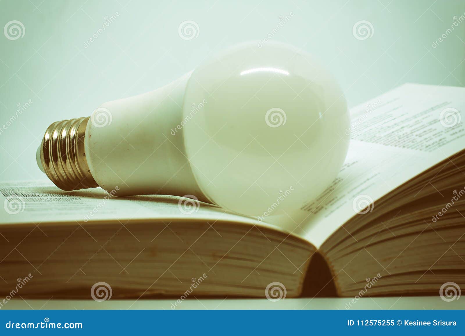 Opened Book With LED Light Bulb On Dark Background Stock Image Image