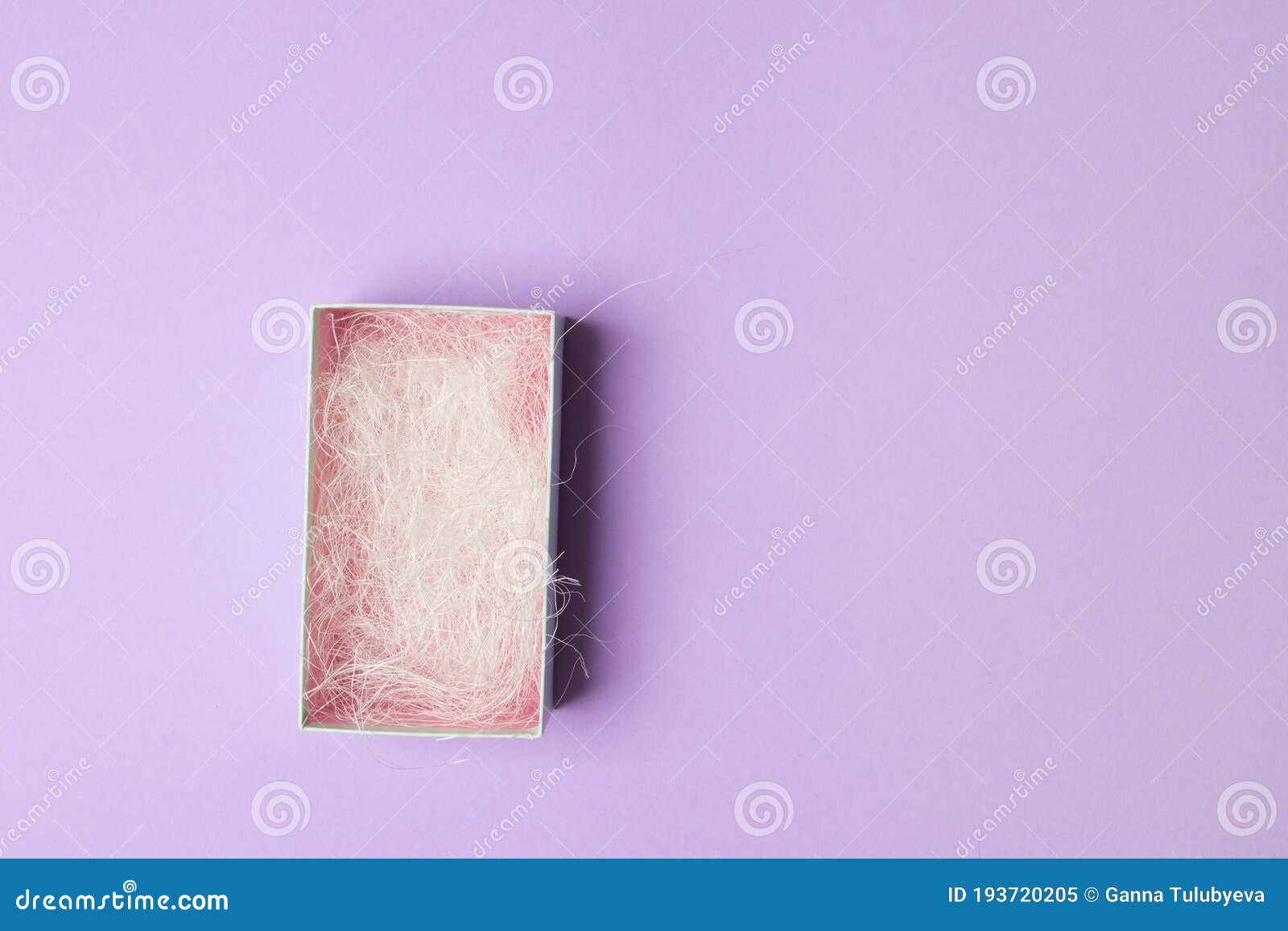 Opened Light Green Box with Filling Material on Purple Background with