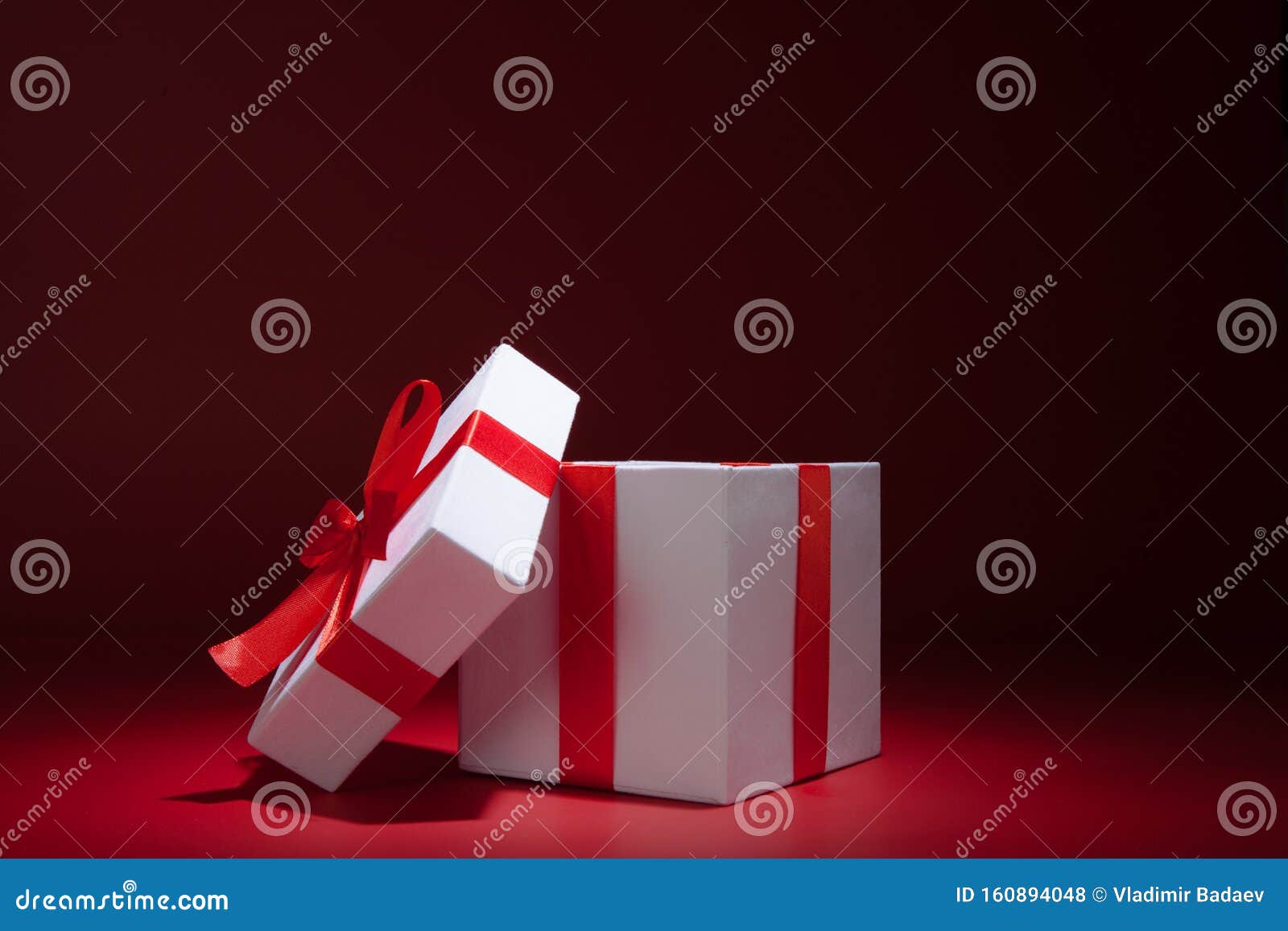 opened white gift box on red background