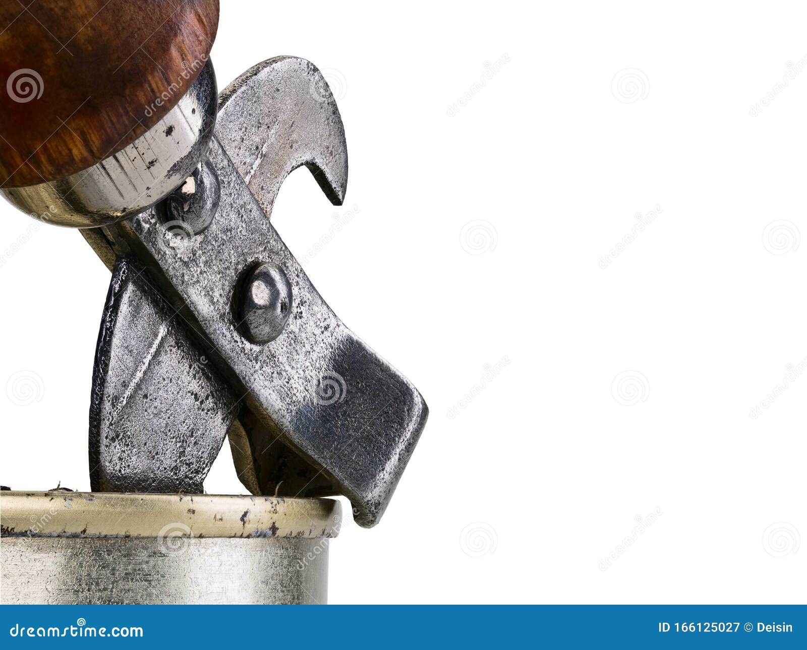 Old style tin opener opening a can, isolated on white background