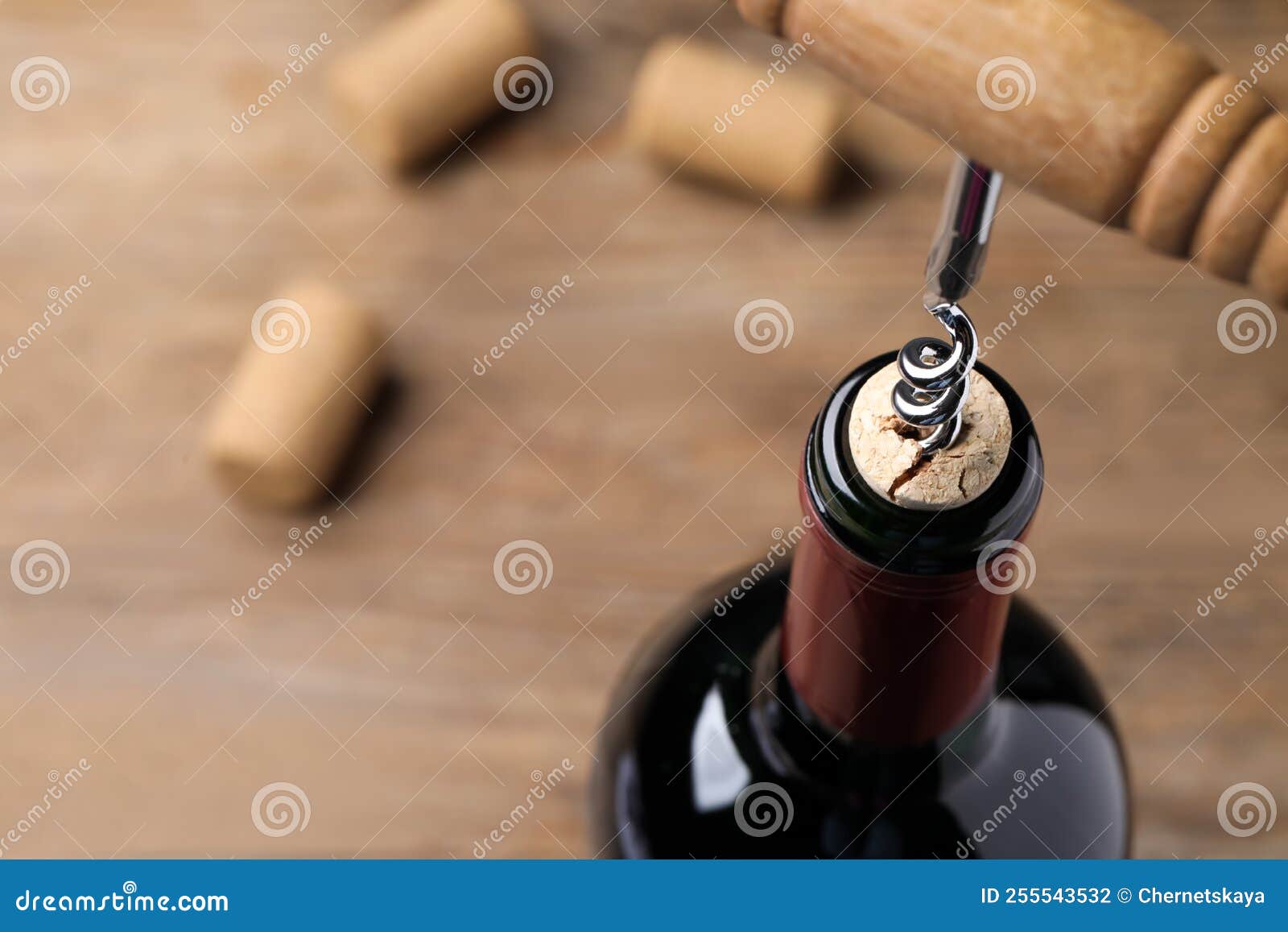 Opening Wine Bottle with Corkscrew on Table, Closeup. Space for Text