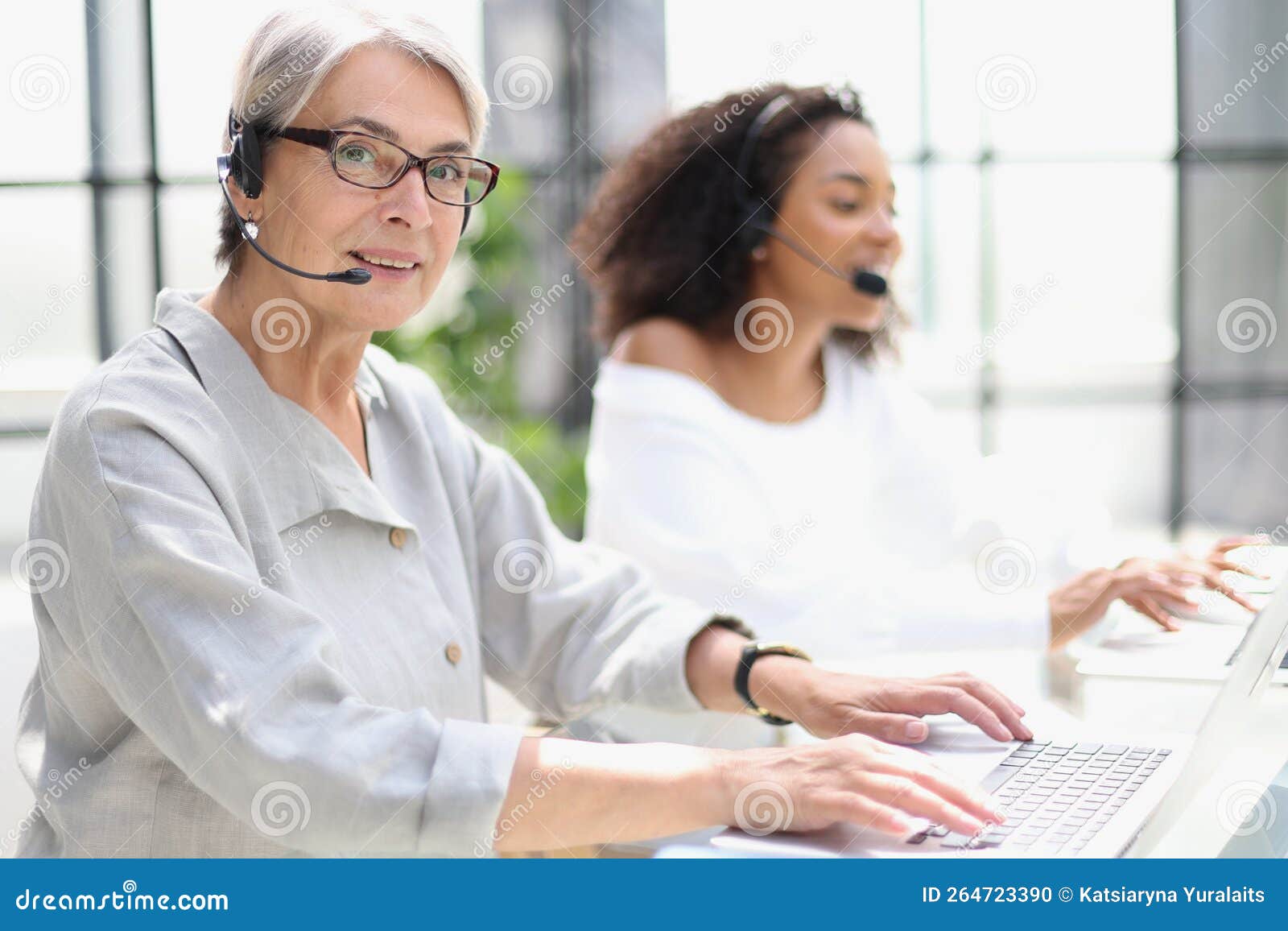 Operator Woman Agent with Headsets Working in a Call Centre. Stock