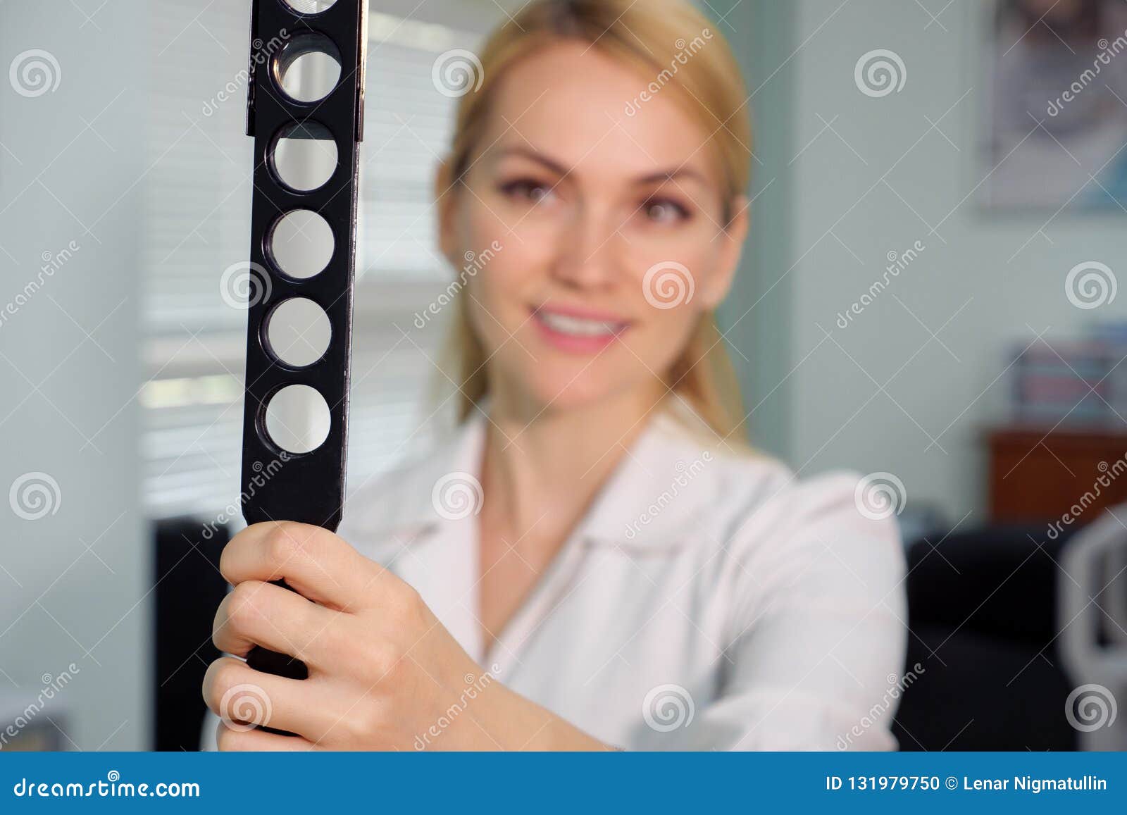 Ophthalmologic Device and Beautiful Smiling Eye Doctor at the a Blurred