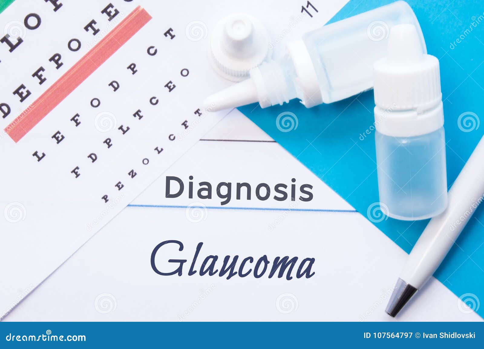 ophthalmology diagnosis glaucoma. snellen eye chart, two bottles of eye drops medications lying on notebook with inscription