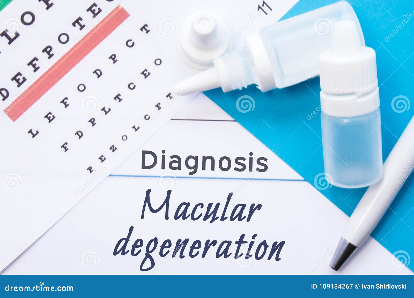 ophthalmology diagnosis macular degeneration. snellen eye chart, two bottles of eye drops medications lying on note with inscr