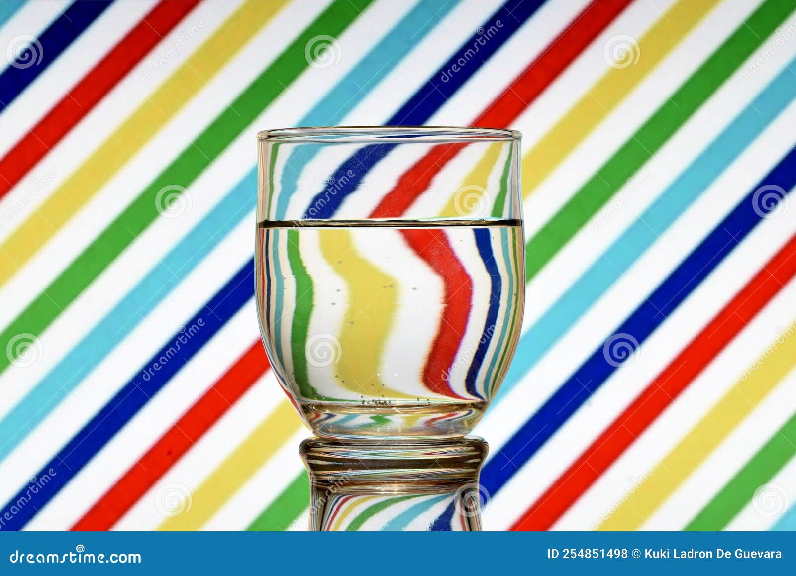 oblique black and white lines reflected in a glass of water