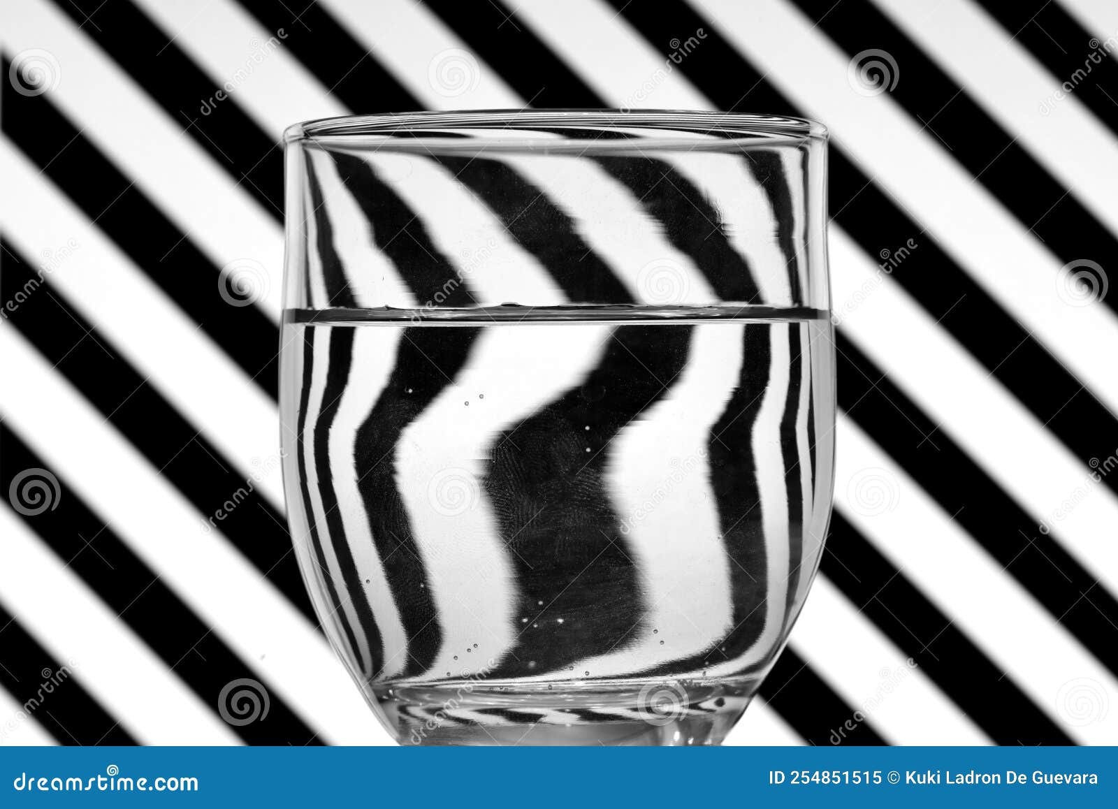 oblique black and white lines reflected in a glass of water
