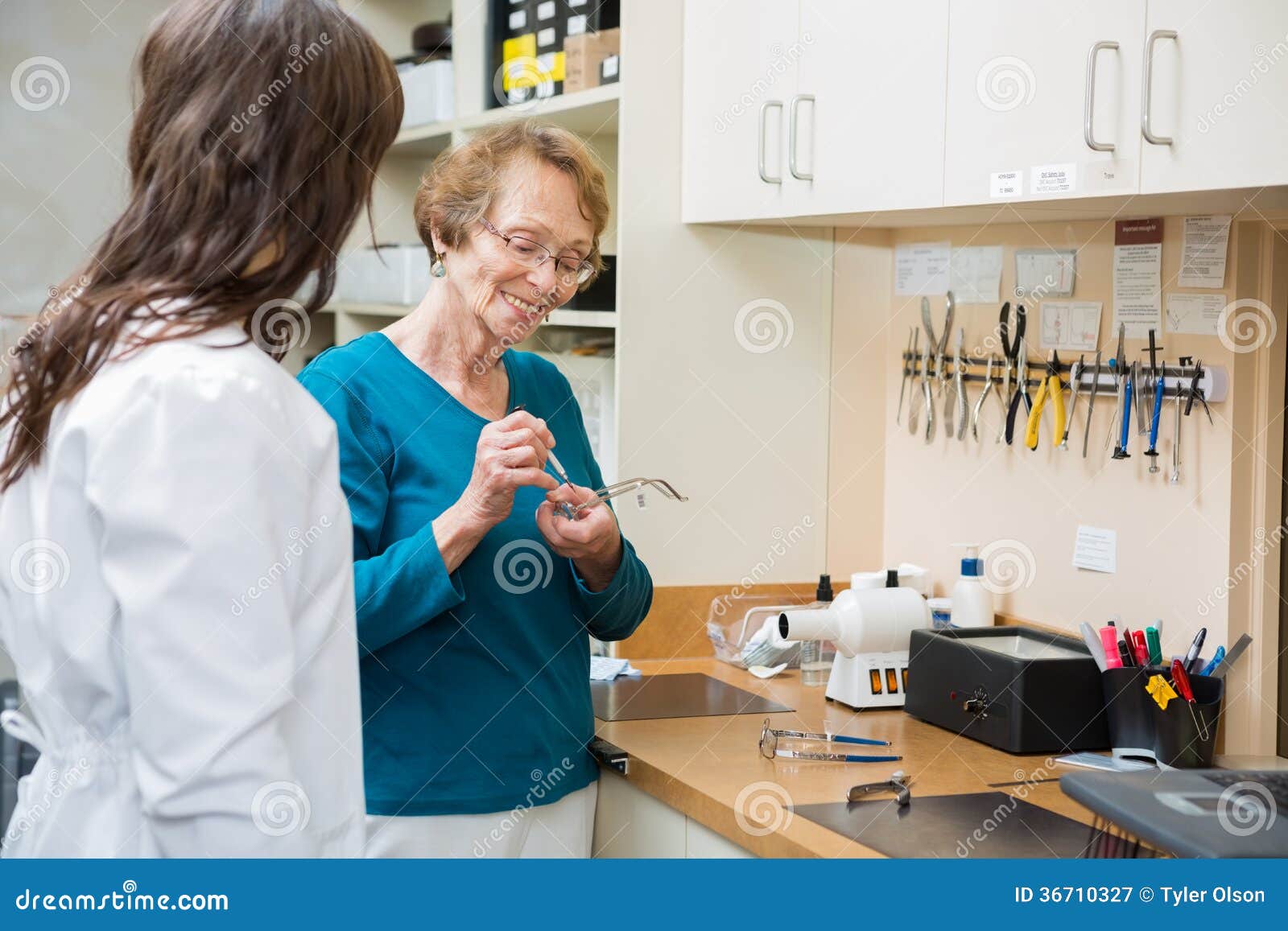 Optician with Female Apprentice Repairing Glasses Stock Image Image
