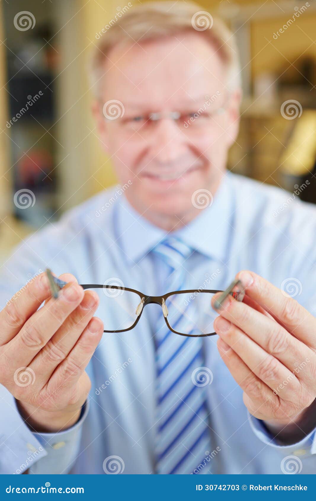Optician Holding Glasses at Stock Image - Image of offer, glasses: 30742703