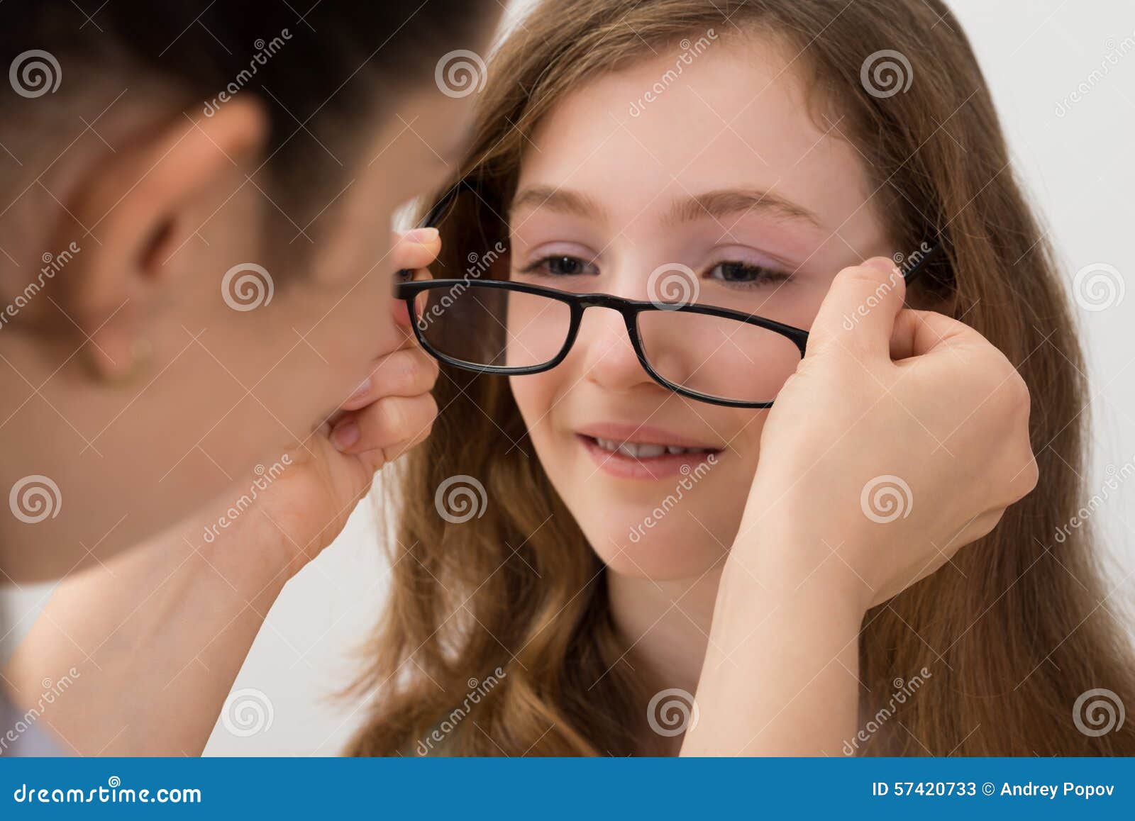 Optician Putting Eyeglasses on a Patient Stock Image Image of optic