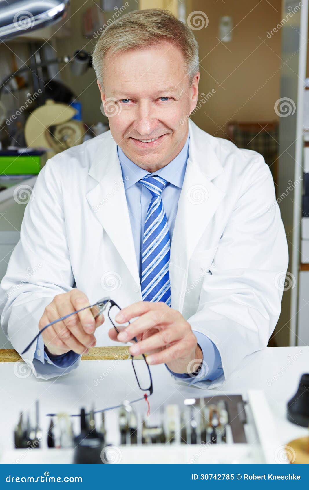 Optician repairing glasses stock image. Image of earpiece 30742785