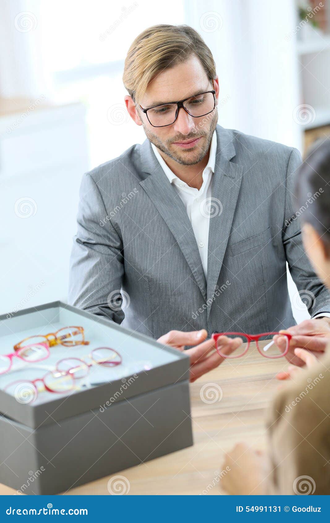 Optician Showing Eyeglasses To Customer Stock Image Image of trendy