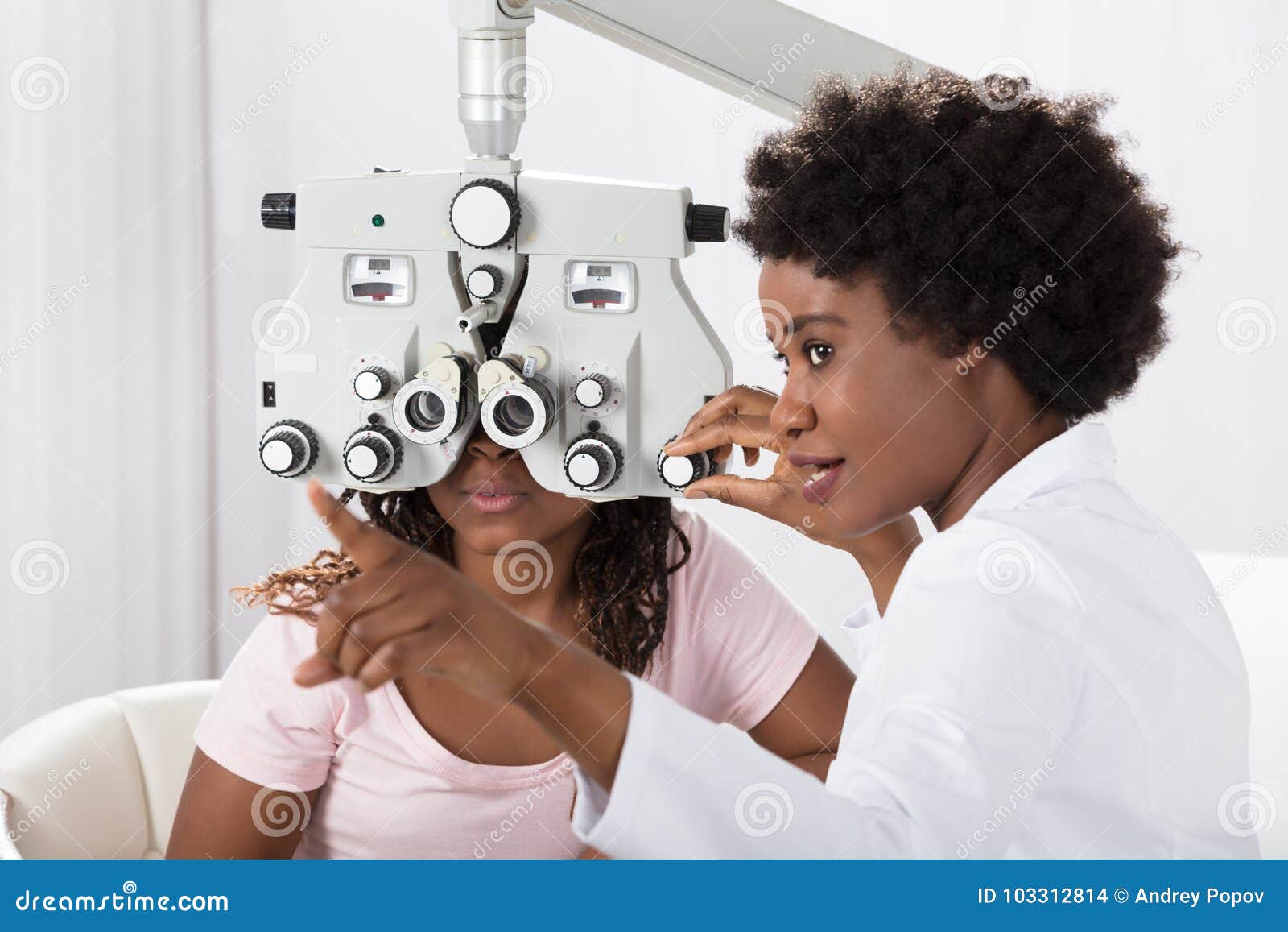 optometrist doing sight testing for patient