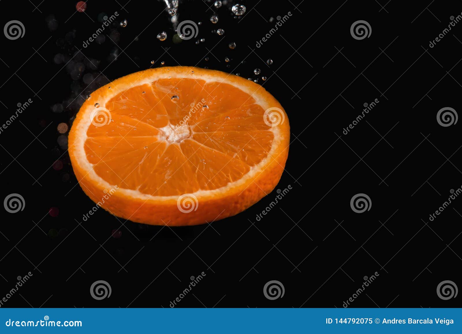 orange slice with bubbles over on black background
