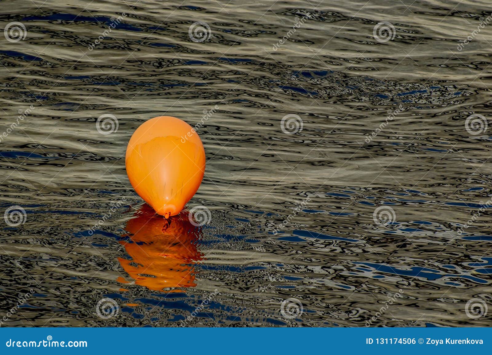 Orange Balloon in the Water of the River. Stock Photo Image of water