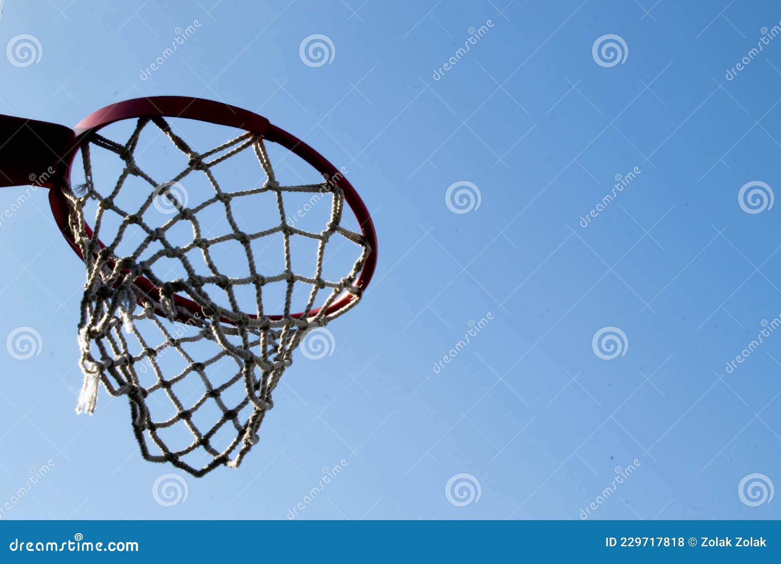 An Orange Basketball Hoop Against a Blue Sky Stock Photo Image of