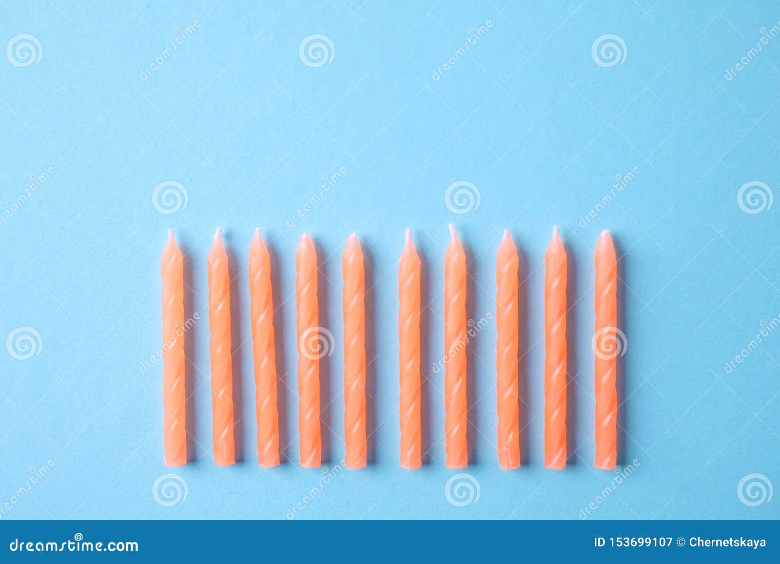 Orange Birthday Candles on Light Blue Background, Space for Text Stock